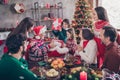 Photo portrait small children receive present box on christmas from santa claus sitting at table with full family Royalty Free Stock Photo