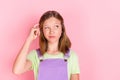 Photo portrait of small uncertain girl having doubt looking blank space isolated on pastel pink color background