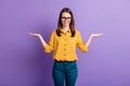 Photo portrait of smiling girl comparing copyspaces on palms of both hands isolated on vibrant purple color background