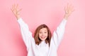 Photo portrait smiling girl wearing hodie amazed cheerful hands over head isolated pastel pink color background