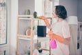 Photo portrait smiling senior woman polishing dust with chemicals keeping spray cleaning the house Royalty Free Stock Photo