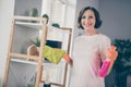 Photo portrait smiling senior woman polishing dust with chemicals keeping spray Royalty Free Stock Photo