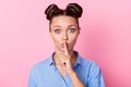 Photo portrait of speechless girl with top-knot hairstyle keeping finger near lips secret staring isolated on pastel