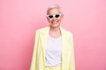 Photo portrait of toothy smiling mature lady in yellow jacket cheerful business boss on vacation isolated over pink