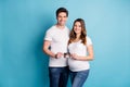 Photo portrait two people couple waiting kid birth holding tummy ultrasound screening photo happy isolated vivid blue Royalty Free Stock Photo