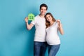 Photo portrait of two people happy couple holding key from new home pregnant wife waiting baby isolated vivid blue color Royalty Free Stock Photo