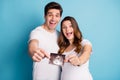 Photo portrait two people happy husband pregnant wife holding belly ultrasound screening photo isolated vibrant blue Royalty Free Stock Photo