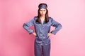 Photo portrait of unhappy grumpy girl with hands on waist isolated on pastel pink colored background