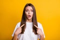 Photo portrait of upset worried girl pointing two fingers at self isolated on bright yellow colored background