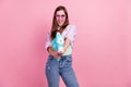 Photo portrait woman smiling overjoyed in sunglass game keeping plastic water gun isolated pastel pink color background Royalty Free Stock Photo