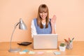 Photo portrait of woman smiling waving hand greeting video call laptop at desk wearing blue vest isolated on pastel