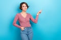 Photo portrait young charming lady wear pink shirt jeans pants point finger empty space advertisement isolated blue Royalty Free Stock Photo