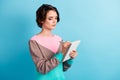 Photo portrait of young concentrated business woman taking notes in organizer writing with pen isolated on vibrant blue Royalty Free Stock Photo