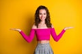 Photo portrait of young girl holding two choices copyspaces in hands palms smiling wearing fuchsia top checkered skirt