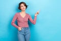 Photo portrait of young suspicious girl wear trendy look directing finger empty space unsure proposition isolated on