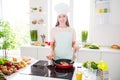 Photo portrait young woman cooking meal wearing heandwear frying red fish Royalty Free Stock Photo