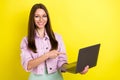 Photo portrait young woman wearing glasses pointing finger computer isolated vivid yellow color background