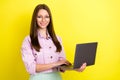 Photo portrait young woman wearing glasses working on laptop isolated vivid yellow color background Royalty Free Stock Photo