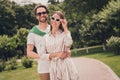 Photo portriat young couple smiling in summer going in park in stylish outfits wearing sunglass