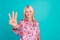 Photo of positive adorable lady wear print blouse showing three fingers isolated teal color background Royalty Free Stock Photo