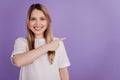 Photo of positive advertiser lady indicate empty space wear casual clothes on violet background