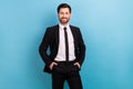 Photo of positive attractive assistant guy dressed black suit smiling arms hands pockets isolated blue color background Royalty Free Stock Photo