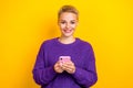 Photo of positive attractive short blonde hair blogger girl hold new apple iphone check stats views subscribers isolated Royalty Free Stock Photo