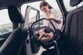 Photo of positive charming mom daughter wear casual outfits putting safety seat inside automobile vehicle Royalty Free Stock Photo