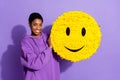 Photo of positive charming transgender person hold emoji smiley pinata wear hoodie isolated violet color background