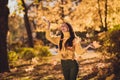 Photo of positive cheerful girl countryside tourist enjoy autumn rest relax holiday in park woods outside throw catch Royalty Free Stock Photo