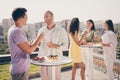 Photo of positive cheerful good mood optimistic smiling groups of friends hanging out drink champagne on rooftop