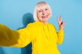 Photo of positive cheerful old woman make selfie show v-sign greeting cool isolated on blue color background