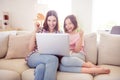 Photo of positive cheerful younger sister sit sofa look laptop winner celebrate indoors inside house home