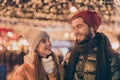 Photo of positive couple newyear date under night outside evening illumination sky wear season winter outerwear