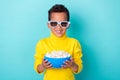 Photo of positive cute boy dressed stylish clothes eyewear hand arm hold snack ready watch film isolated on cyan color