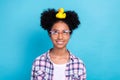 Photo of positive dreamy girl dressed checkered shirt eyewear holding head plastic duck toy isolated blue color