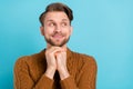 Photo of positive dreamy happy young man look empty space imagine think isolated on blue color background