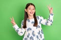 Photo of positive energetic schoolkid make v-sign dancing spring school disco over green color background