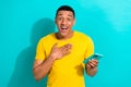 Photo of positive excited guy wear yellow t-shirt communicating instagram twitter telegram facebook isolated teal color