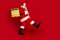 Photo of positive excited retired man wear santa claus costume holding delivery backpack empty space isolated red color