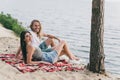 Photo of positive funny young couple dressed casual outfits sunbathing beach outdoors countryside Royalty Free Stock Photo