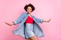 Photo of positive girlish dream african lady posing wear jeans jacket mini skirt isolated pink color background Royalty Free Stock Photo