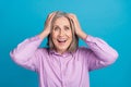 Photo of positive glad crazy lady wear trendy clothes hand head rejoice nice offer good mood isolated on blue color Royalty Free Stock Photo