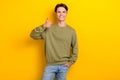 Photo of positive glad person demonstrate thumb up approval isolated on yellow color background