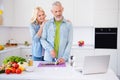 Photo of positive good mood handsome husband watch video in laptop prepare breakfast for wife cut chop cucumber Royalty Free Stock Photo