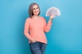 Photo of positive good mood lady dressed coral shirt rising money cash fan isolated blue color background Royalty Free Stock Photo