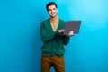 Photo of positive good mood man wear green cardigan spectacles communicating modern device isolated blue color Royalty Free Stock Photo