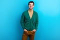 Photo of positive good mood man wear green cardigan spectacles smiling isolated blue color background Royalty Free Stock Photo