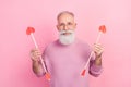 Photo of positive grey beard hair old man hold arrows wear eyewear sweater isolated on pink background Royalty Free Stock Photo