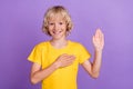 Photo of positive happy charming boy hold hand chest give oath pledge honest isolated on violet color background